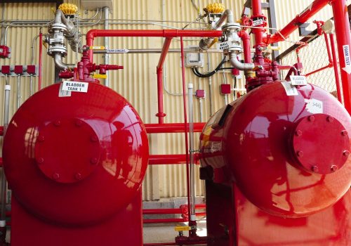 Officials from the 39th Civil Engineer Squadron and several contracted companies conduct the final certification and test of the new fire suppression system for the 414th Expeditionary Reconnaissance Squadron hangar June 15, 2012, at Incirlik Air Base, Turkey. The $250,000 system protects $12 million of equipment from fire damage by extinguishing flames with fire suppressant foam in less than four minutes. The final test indicated that the fire suppressant foam surpassed the designated 4-minute height requirement in only 50 seconds. (U.S. Air Force photo by Capt. Gina McKeen/Released)